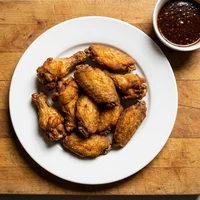 Alitas fritas, Pizzería El Mostrador